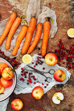 Apples, carrots, beet, cabbage, grapefruit, lemon sliced above rustic wooden table. Detox and healthy breakfast. Clean eating breakfast concept. Colorful food collage. Food collage on a rustic surfaceの写真素材
