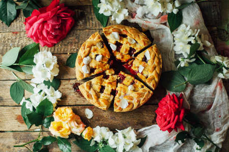Homemade cherry and strawberry  pie on rustic background. Delicious Homemade Cherry Pie with a Flaky...
