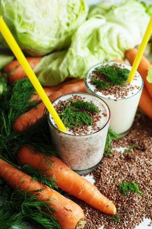 Glass of yogurt with crushed flax seeds  on a white background. Cocktail from kefir  in a transparent glass. Fresh homemade Kefir shake with flax seeds for a breakfast. Bio homemade dairy beverage.の写真素材