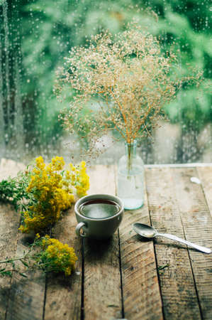 Romantic background with cup of tea, flowers and open book over wooden table. coffee cup book and white plumeria flower on table,の写真素材