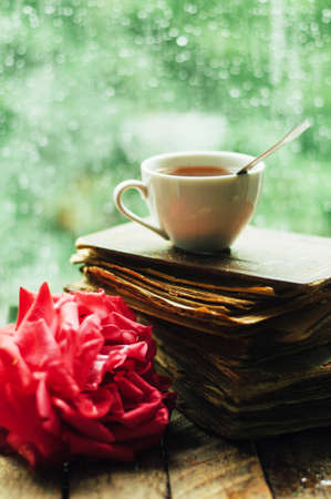 Romantic background with cup of tea, flowers and open book over wooden table. coffee cup book and white plumeria flower on table,の写真素材