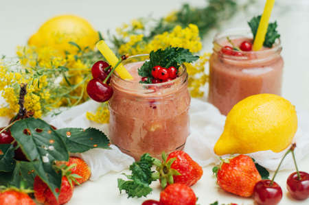 banana and strawberry smoothie. Two Cold Strawberry Banana Smoothies in Glasses with Ingredients on Kitchen Table. Strawberry Banana Smoothie made with fresh Ingredients. Fresh strawberry  smoothieの写真素材