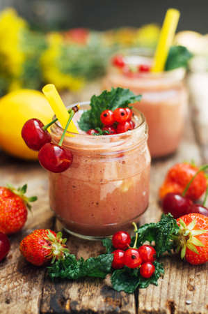 banana and strawberry smoothie. Two Cold Strawberry Banana Smoothies in Glasses with Ingredients on Kitchen Table. Strawberry Banana Smoothie made with fresh Ingredients. Fresh strawberry  smoothieの写真素材