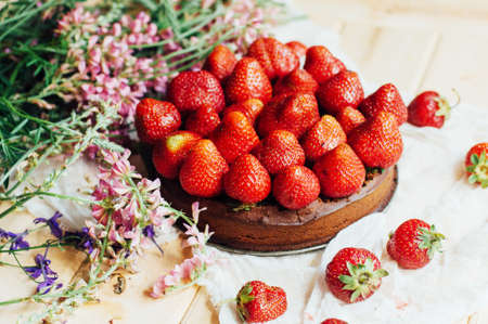 strawberry tart, strawberry shortcake, strawberry jam. serving homemade strawberry cake or pie on wooden rustic table. Strawberry tart on wooden tray, on rustic wooden backgroundの写真素材