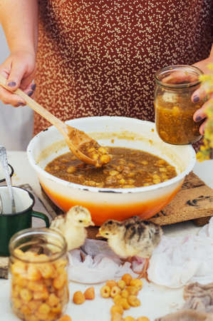 raspberries jam. Female hand making jam, on a rustic white table. Country  styling. Cooking...