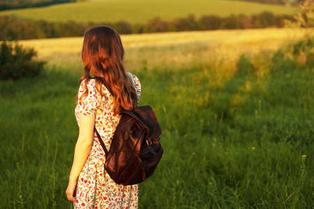 Woman with backpack in the nature. Young beautiful woman portrait .Girl with the wind in her hair....