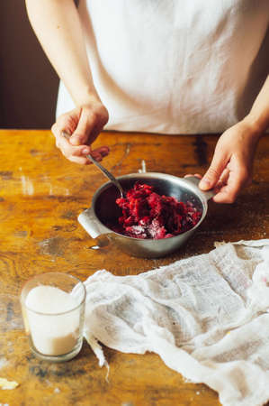 Ingredients for baking cake stuffed with fresh cherry pie. Female preparing cherry pie. Rustic dark style. See series recipe step on step. Womans hands. Recipe for homemade pie on short pastryの写真素材