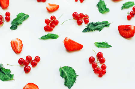 Colorful mix of fruits on white background. View from above. Colorful pattern made of  leaves and strawberries. Strawberries. Fruit background. Flavor Pattern With Lemon, Mint and Strawberries.の写真素材