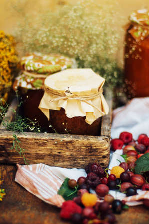 homemade strawberry pits. dessert made of must and flour placed inside small jars. Homemade raspberry jam ready for storage. jar filled with homemade apricot jamの写真素材