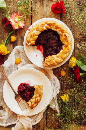 Tart with fresh berries.  Homemade  tart decorated with berries. Food: Cranberry and Raspberry upside down cake. a very natural and easy cake with olive oil and topped with caramelized raspberriesの写真素材