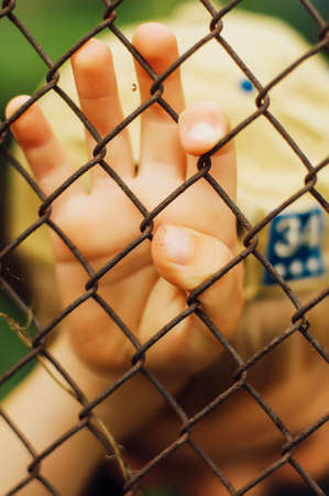 Portrait of smiling seven year old boy. Seven year old boy  with brown eyes and blond hair. Young boy in a black T-shirt and denim overalls outdoor.  Boy's portrait.の写真素材