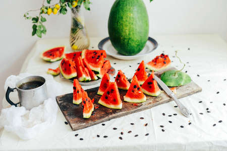 White cantaloupe and watermelon sliced on the table. Eating appetizer with family. Overhead view of melons on white background. Fresh Watermelon. remains of an eaten watermelonの写真素材