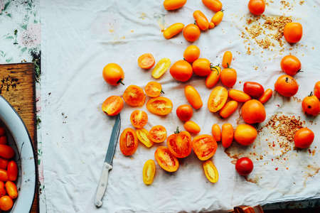 Tomato on wooden table. Freshly Picked red Tomatoes. Variation of tomatoes on wooden surface. Vegetables in the section. Harvesting. Healthy food from the garden.の写真素材