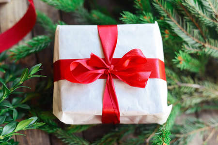 Extensive series of holiday shots with a variety of props and backgrounds. Lots of copyspace for ads. Christmas presents on wooden table. A couple of gifts wrapped in Christmas themed wrapping paper.の写真素材