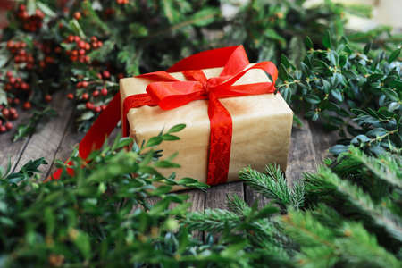 Extensive series of holiday shots with a variety of props and backgrounds. Lots of copyspace for ads. Christmas presents on wooden table. A couple of gifts wrapped in Christmas themed wrapping paper.の写真素材