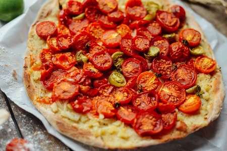Pizza with tomatoes, shallot and fresh herbs. Cherry Tomato Wood Fired Pizza. Homemade margherita...