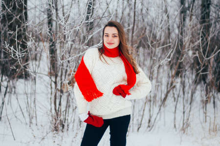 Female portrait outdoors serious expression. Young woman outside wearing warm winter clothing. ...