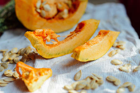 Pumpkin porridge and pumpkins on black wooden table. Plate pumpkin porridge is on a brown wooden table. pumpkin porridge. Millet porridge with pumpkin.の写真素材