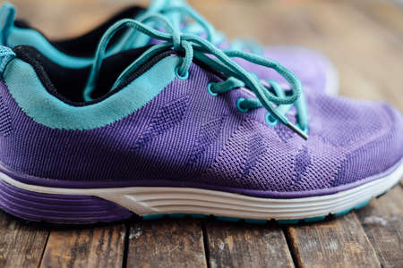 set for sports on wooden table, closeup. Rope and sneakers on the dark wooden background.  Shoe on wooden background. Sport clothes and accessories on a wooden background, View from aboveの写真素材