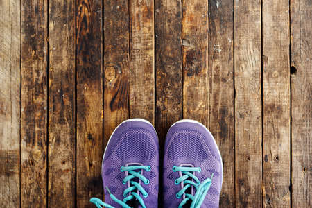 set for sports on wooden table, closeup. Rope and sneakers on the dark wooden background.  Shoe on wooden background. Sport clothes and accessories on a wooden background, View from aboveの写真素材
