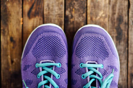 set for sports on wooden table, closeup. Rope and sneakers on the dark wooden background.  Shoe on wooden background. Sport clothes and accessories on a wooden background, View from aboveの写真素材