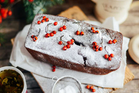Rustic open apple and pear pie in rustic table setting. Baked pears wrapped in  pastry. Fall colours. A delicious chocolate cake with pear filling berries decorationの写真素材