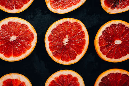 Fresh red pomegranate and grapefruit On a wooden background. Pomegranate in  plate on  wood background.  Pomegranate  on wood textured background. Overhead view image.の写真素材