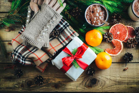 Extensive series of holiday shots with a variety of props and backgrounds. Lots of copyspace for ads. Christmas presents on wooden table. A couple of gifts wrapped in Christmas themed wrapping paper.の写真素材