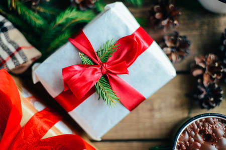 Extensive series of holiday shots with a variety of props and backgrounds. Lots of copyspace for ads. Christmas presents on wooden table. A couple of gifts wrapped in Christmas themed wrapping paper.の写真素材