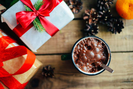 Extensive series of holiday shots with a variety of props and backgrounds. Lots of copyspace for ads. Christmas presents on wooden table. A couple of gifts wrapped in Christmas themed wrapping paper.の写真素材