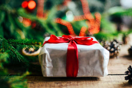 Extensive series of holiday shots with a variety of props and backgrounds. Lots of copyspace for ads. Christmas presents on wooden table. A couple of gifts wrapped in Christmas themed wrapping paper.の写真素材