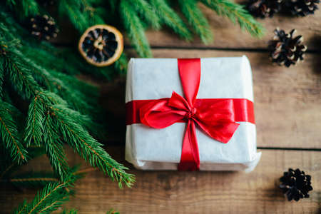 Extensive series of holiday shots with a variety of props and backgrounds. Lots of copyspace for ads. Christmas presents on wooden table. A couple of gifts wrapped in Christmas themed wrapping paper.の写真素材
