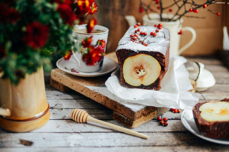 Rustic open apple and pear pie in rustic table setting. Baked pears wrapped in  pastry. Fall...