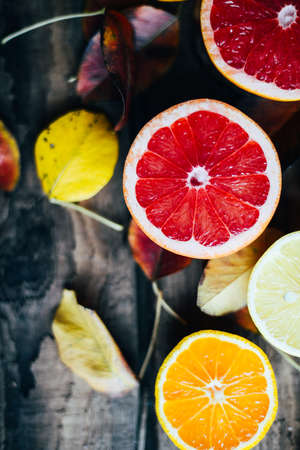 Fresh fruits. Mixed fruits background. Healthy eating, dieting. Background of healthy fresh fruits. Fruit salad - diet, healthy breakfast. pomegranate, persimmon, tangerine, banana, lemonの写真素材