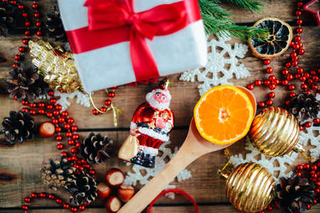 Extensive series of holiday shots with a variety of props and backgrounds. Lots of copyspace for ads. Christmas presents on wooden table. A couple of gifts wrapped in Christmas themed wrapping paper.の写真素材