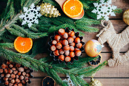 Extensive series of holiday shots with a variety of props and backgrounds. Lots of copyspace for ads. Christmas presents on wooden table. A couple of gifts wrapped in Christmas themed wrapping paper.の写真素材