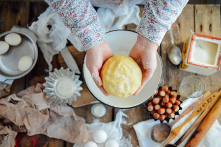 Homemade bakery making, gingerbread cookies close-up.  xmas sweet, winter holidays. Hands roll out gingerbread dough on board. Cookies or pie preparing. Baking ingredients. Christmas New Year conceptの写真素材