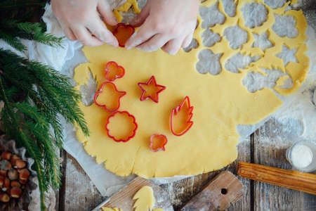 Homemade bakery making, gingerbread cookies close-up.  xmas sweet, winter holidays. Hands roll out gingerbread dough on board. Cookies or pie preparing. Baking ingredients. Christmas New Year conceptの写真素材