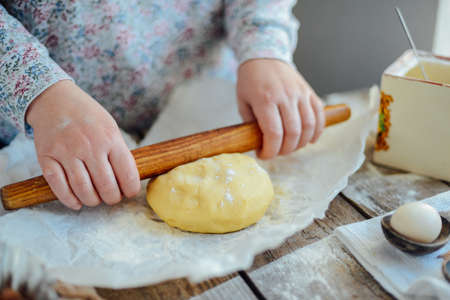 Homemade bakery making, gingerbread cookies close-up.  xmas sweet, winter holidays. Hands roll out gingerbread dough on board. Cookies or pie preparing. Baking ingredients. Christmas New Year conceptの写真素材