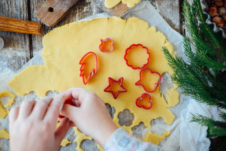Homemade bakery making, gingerbread cookies close-up.  xmas sweet, winter holidays. Hands roll out gingerbread dough on board. Cookies or pie preparing. Baking ingredients. Christmas New Year conceptの写真素材