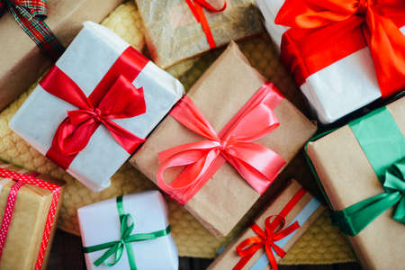 Extensive series of holiday shots with a variety of props and backgrounds. Lots of copyspace for ads. Christmas presents on wooden table. A couple of gifts wrapped in Christmas themed wrapping paper.の写真素材