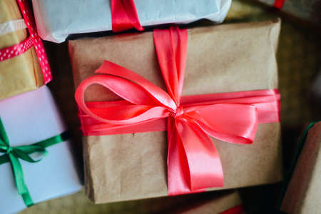 Extensive series of holiday shots with a variety of props and backgrounds. Lots of copyspace for ads. Christmas presents on wooden table. A couple of gifts wrapped in Christmas themed wrapping paper.の写真素材