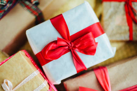 Extensive series of holiday shots with a variety of props and backgrounds. Lots of copyspace for ads. Christmas presents on wooden table. A couple of gifts wrapped in Christmas themed wrapping paper.の写真素材