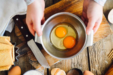 Close up view of baker kneading dough. Homemade bread. Hands preparing bread dough on wooden table. Preparing traditional homemade bread. Woman hands kneading fresh dough for making breadの写真素材