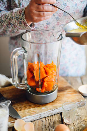 Close up view of baker kneading dough. Homemade bread. Hands preparing bread dough on wooden table. Preparing traditional homemade bread. Woman hands kneading fresh dough for making breadの写真素材