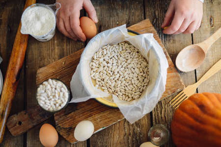 Close up view of baker kneading dough. Homemade bread. Hands preparing bread dough on wooden table. Preparing traditional homemade bread. Woman hands kneading fresh dough for making breadの写真素材