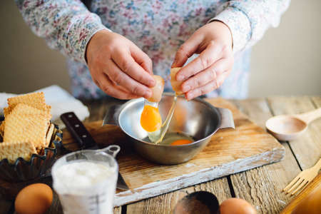 Close up view of baker kneading dough. Homemade bread. Hands preparing bread dough on wooden table. Preparing traditional homemade bread. Woman hands kneading fresh dough for making breadの写真素材