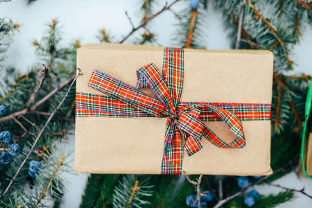 Extensive series of holiday shots with a variety of props and backgrounds. Lots of copyspace for ads. Christmas presents on wooden table. A couple of gifts wrapped in Christmas themed wrapping paper.の写真素材