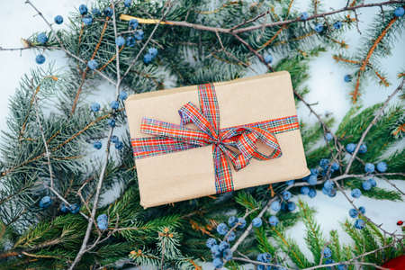 Extensive series of holiday shots with a variety of props and backgrounds. Lots of copyspace for ads. Christmas presents on wooden table. A couple of gifts wrapped in Christmas themed wrapping paper.の写真素材