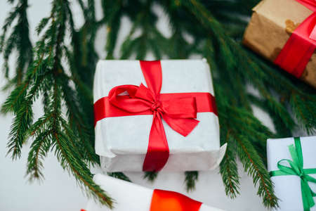 Extensive series of holiday shots with a variety of props and backgrounds. Lots of copyspace for ads. Christmas presents on wooden table. A couple of gifts wrapped in Christmas themed wrapping paper.の写真素材